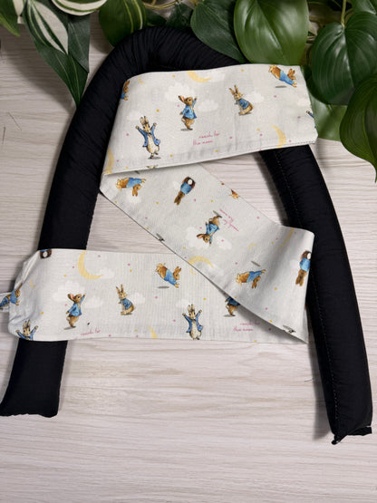 Rabbit-patterned draught stopper cover sitting on a the draught stopper insert  against a wooden background