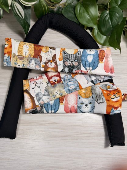 cat-patterned draught stopper cover sitting on a the draught stopper insert  against a wooden background