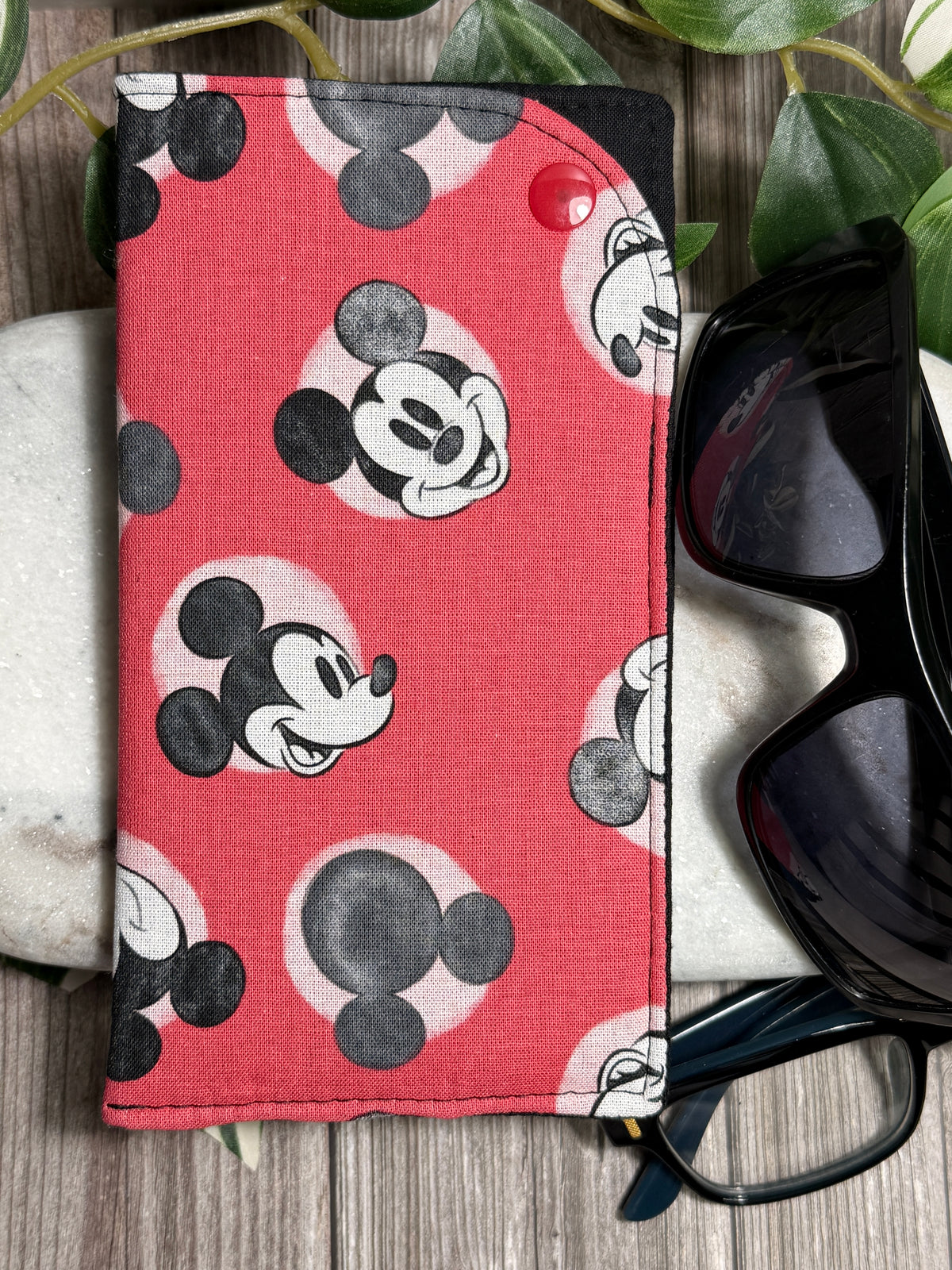 Glasses Cases with a Mickey Mouse pattern on a wooden surface with sunglasses and glasses
