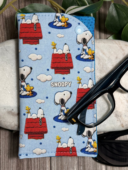 Glasses Case with a Snoopy-themed pattern with glasses on a wooden surface