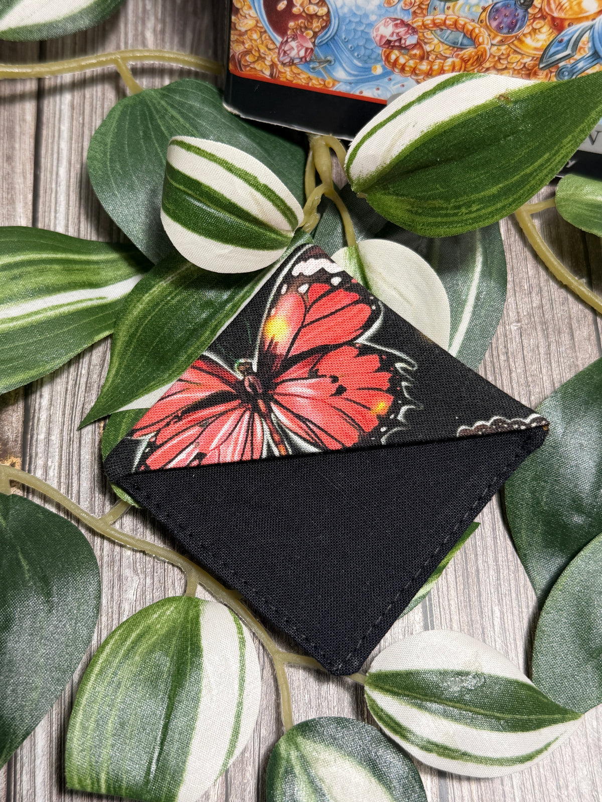 fabric book mark with a butterfly print and a black background.
