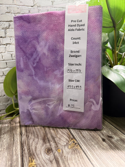 Hand Dyed purple cross stitch adia on a wooden surface