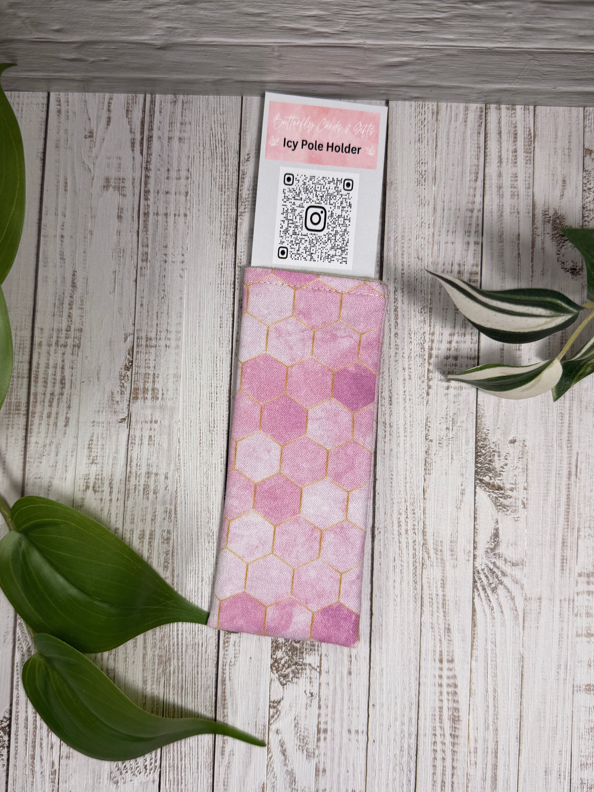 Fabric Icy Pole Holder with a pink hex pattern on a wooden surface