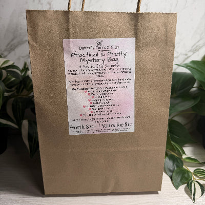 Brown paper bag with a label on a marble surface with plants in the background
