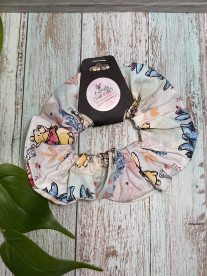 Fabric scrunchie with cartoon characters on a wooden surface