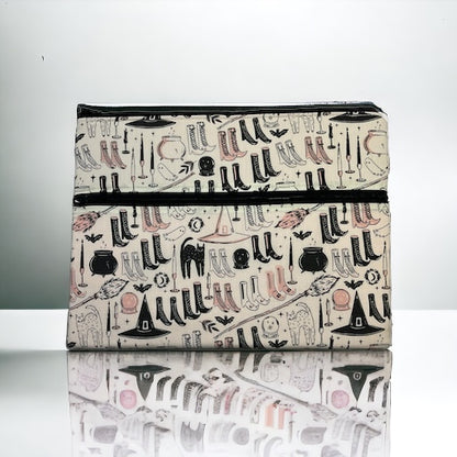 Ipad/tablet sleeve with a witch them fabric on a marble surface