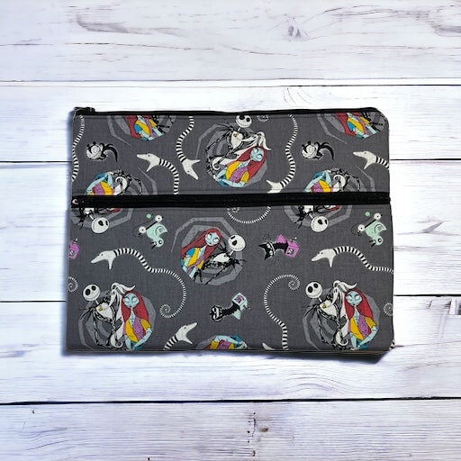 Ipad/tablet sleeve with Jack and Sally pattern on a wooden surface
