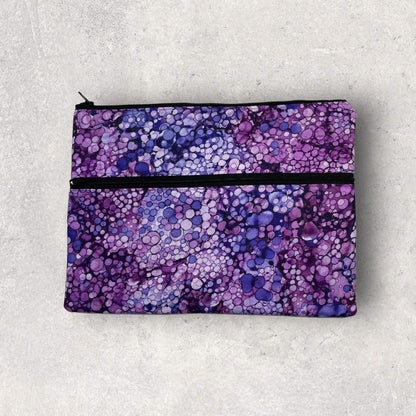 Ipad/tablet sleeve with  a purple bubble pattern fabric on a marble surface